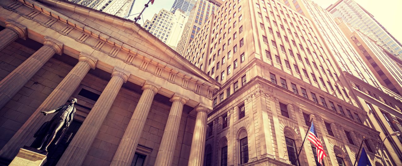 Vintage toned Wall Street at sunset, Manhattan, New York City, USA.